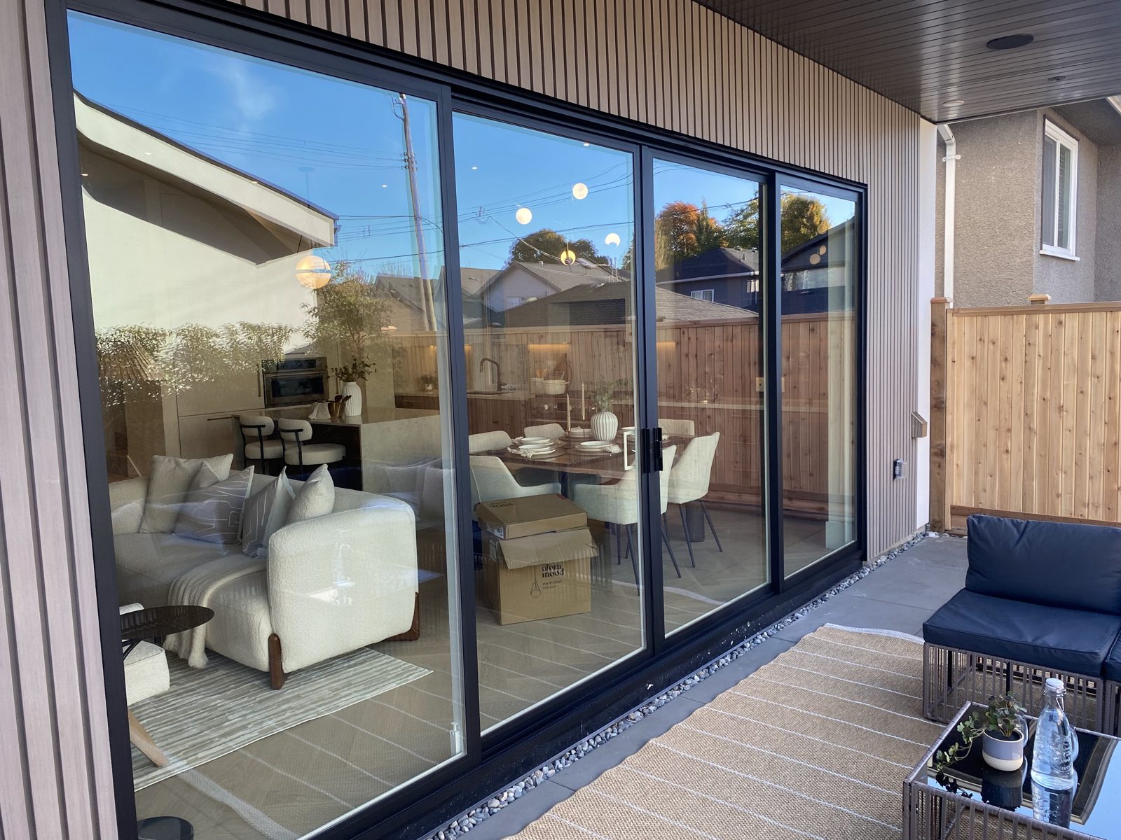 The same patio door after refinishing, with clean black frames